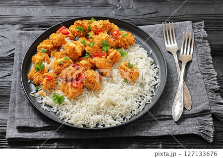 panko-breaded chicken bites with rice and sauce 127133676