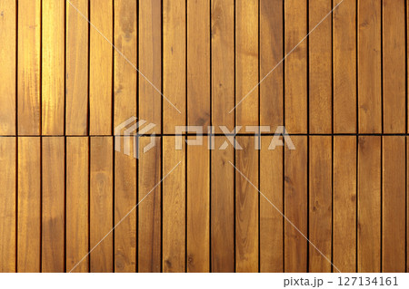 Decorative surface made of brown wooden slats. 127134161
