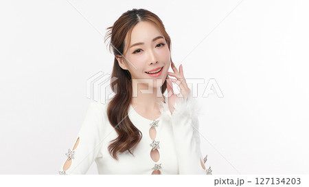 A beautiful young Asian woman with clean, fresh skin against a white background. Skincare, facial treatment, cosmetology, beauty, and spa. An elegant portrait of an Asian woman. A beautiful young Asian woman with clean, fresh skin against a white background. Skincare, facial treatment, cosmetology, beauty, and spa. An elegant portrait of an Asian woman. 127134203