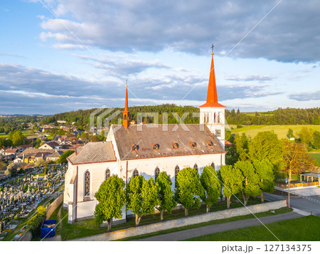 Saint Mary Magdalene Church stands amidst lush greenery in Bohutin, Czechia, showcasing its striking architecture with twin spires. The serene environment invites peaceful reflection. Saint Mary Magdalene Church stands amidst lush greenery in Bohutin, Czechia, showcasing its striking architecture with twin spires. The serene environment invites peaceful reflection. 127134375