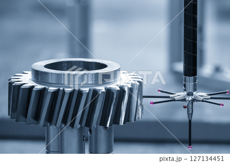 The CMM machine measuring the metal gear parts by modular probe in the light blue scene. The CMM machine measuring the metal gear parts by modular probe in the light blue scene. 127134451