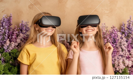 Two smiling girls experience virtual reality together, immersed in a digital world amidst a backdrop of lovely purple flowers Two smiling girls experience virtual reality together, immersed in a digital world amidst a backdrop of lovely purple flowers 127135154
