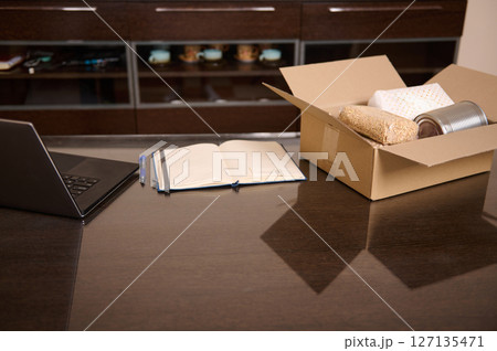 Workspace with Delivery Box, Supplies, and Laptop for Online Business Management 127135471