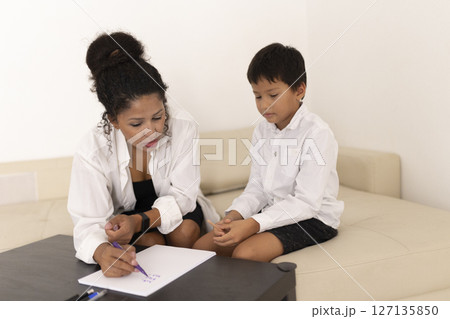 Child psychologist helping a sad little boy during therapy session Child psychologist helping a sad little boy during therapy session 127135850