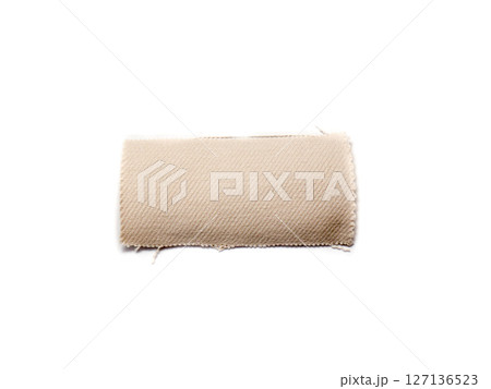 A piece of beige material isolated on a white background. A piece of beige material isolated on a white background. 127136523