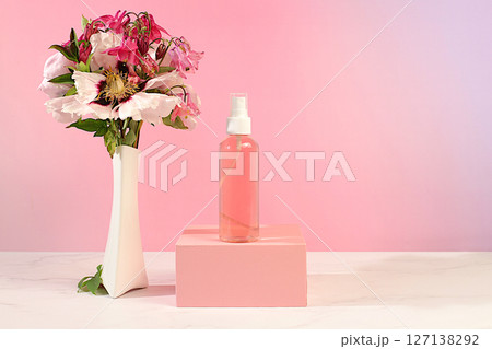 Wellness composition with rose water, fresh flowers of mountain peony and columbine, spa salon advertising card, natural self-care and healthy lifestyle concept, abstract composition with flowers. Wellness composition with rose water, fresh flowers of mountain peony and columbine, spa salon advertising card, natural self-care and healthy lifestyle concept, abstract composition with flowers. 127138292