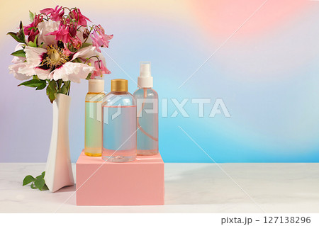 Spa salon advertising card, Wellness composition with rose water, fresh flowers of mountain peony and columbine, concept of natural self-care and healthy lifestyle, abstract composition with flowers. 127138296