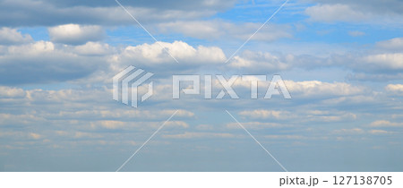 clear blue sky with a few clouds. The sky is very bright and the clouds are scattered throughout. clear blue sky with a few clouds. The sky is very bright and the clouds are scattered throughout. 127138705