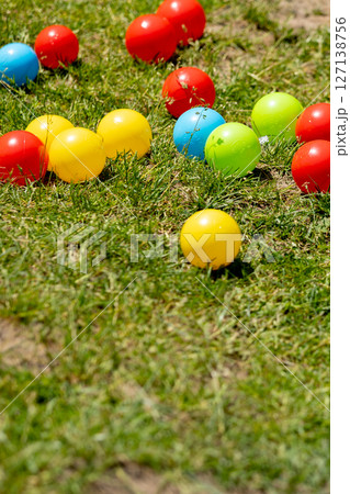 Multi colored balls on the green grass 127138756