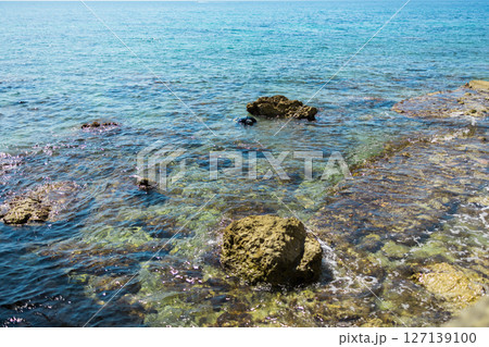 Blue sea and rocky coastline. Coastal nature and clear water landscape. 127139100