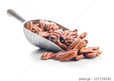 Peeled pecan nuts in scoop isolated on white background. Peeled pecan nuts in scoop isolated on white background. 127139382