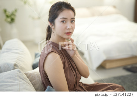 ソファ座る20代女性　ビューティーイメージ 127141227