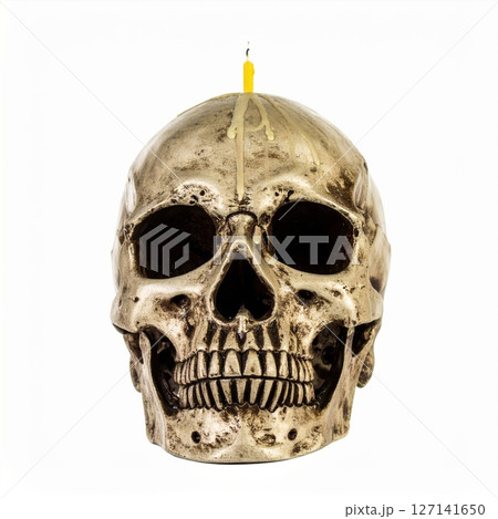 Human Skull with Lit Yellow Candle on White Background 127141650