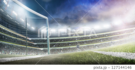 Beautiful professional football stadium. Football goals. Large sports arena. Professional sports advertising background with lights, fans and flags Beautiful professional football stadium. Football goals. Large sports arena. Professional sports advertising background with lights, fans and flags 127144146