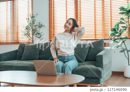 Young asian woman feeling pain in neck and shoulder 127146090