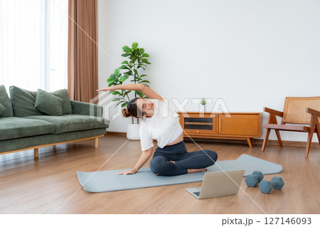 Young Asian woman stretching yoga workout on exercise mat 127146093