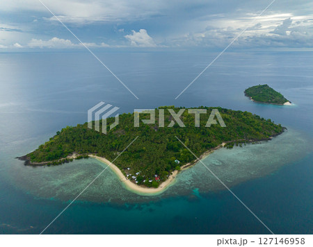 Topical Island with sandy beach under blue sky and clouds. Buh-Buh Island in Zamboanga, Philippines. 127146958