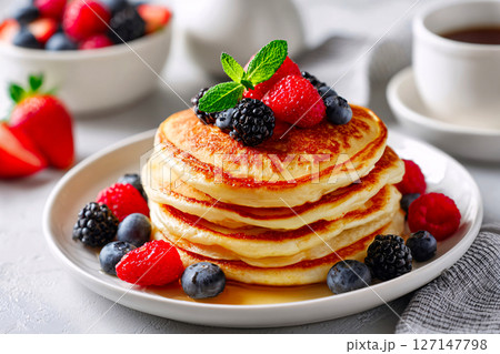 American pancakes in soft daylight, styled cleanly on white in a sunlit cozy corner 127147798