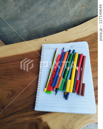 Back to School Essentials: Wooden Desk with Notebook and Bright Markers Back to School Essentials: Wooden Desk with Notebook and Bright Markers 127149649