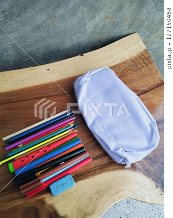 Stationery on wooden table with notebook, colorful markers, school supplies Stationery on wooden table with notebook, colorful markers, school supplies 127150468