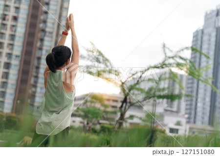Asian woman wellness from fitness yoga workout. stretching exercise reduces medical shoulder pain inflammation and muscle strain injury risk. Urban city healthcare promotes wellness at sunset Asian woman wellness from fitness yoga workout. stretching exercise reduces medical shoulder pain inflammation and muscle strain injury risk. Urban city healthcare promotes wellness at sunset 127151080