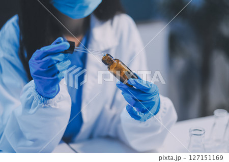 Research, experiment and medical trial being done by a scientist in a lab, science facility or hospital. One young, serious and professional researcher organizing, sorting or making a discovery 127151169