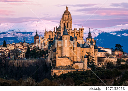 Segovia Alcazar and Cathedral stand majestically against the snowy Guadarrama mountains. 127152058