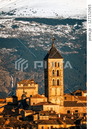 Segovia cityscape, with the iconic tower rising against the snowy Guadarrama mountains. 127152065