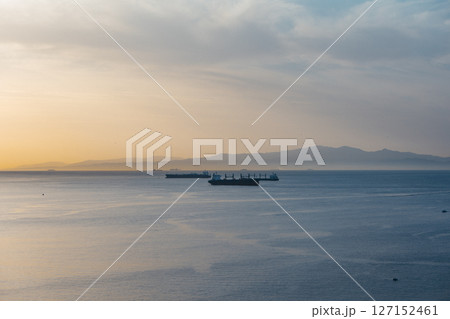 Sunset Over the Strait of Gibraltar with Cargo Ships and Iberian Peninsula View from Ceuta, Spain Sunset Over the Strait of Gibraltar with Cargo Ships and Iberian Peninsula View from Ceuta, Spain 127152461