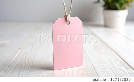 Blank brown paper price tag with string on a natural wooden background Blank brown paper price tag with string on a natural wooden background 127152829