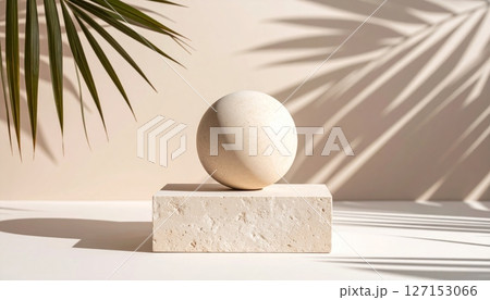 A white sphere, resembling a raw egg, rests in the sand under a coconut palm tree on the beach, casting a gentle shadow A white sphere, resembling a raw egg, rests in the sand under a coconut palm tree on the beach, casting a gentle shadow 127153066