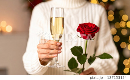 Celebratory champagne glasses and red roses for a romantic toast 127153124