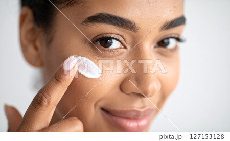 Young woman's natural beauty routine includes applying mascara to her clean eyelashes for a cosmetic facial treatment 127153128