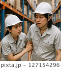 倉庫内で体調を崩している作業者に声をかけている作業者に声をかけている 127154296