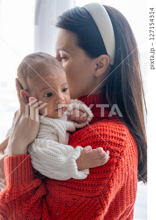 Tender Moment Between Mother and Baby by the Window Tender Moment Between Mother and Baby by the Window 127154314