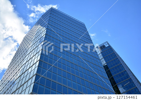 Modern sustainable glass office buildings. Exterior view of corporate headquarters glass buildings architecture.Glass windows in energy-efficient buildings. Financial business center buildings.  127154461