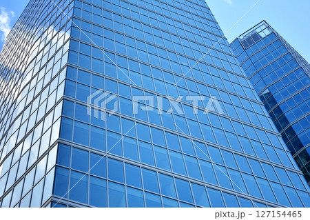 Modern sustainable glass office buildings. Exterior view of corporate headquarters glass buildings architecture.Glass windows in energy-efficient buildings. Financial business center buildings.  127154465