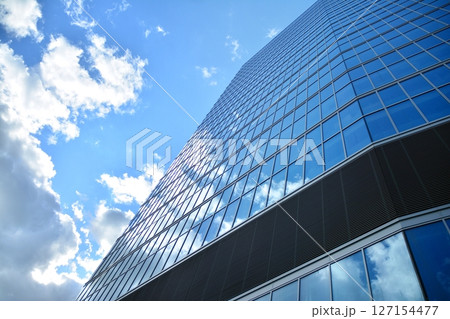 Modern sustainable glass office buildings. Exterior view of corporate headquarters glass buildings architecture.Glass windows in energy-efficient buildings. Financial business center buildings. Modern sustainable glass office buildings. Exterior view of corporate headquarters glass buildings architecture.Glass windows in energy-efficient buildings. Financial business center buildings. 127154477