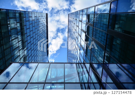 Modern sustainable glass office buildings. Exterior view of corporate headquarters glass buildings architecture.Glass windows in energy-efficient buildings. Financial business center buildings.  127154478