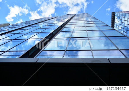Modern sustainable glass office buildings. Exterior view of corporate headquarters glass buildings architecture.Glass windows in energy-efficient buildings. Financial business center buildings. Modern sustainable glass office buildings. Exterior view of corporate headquarters glass buildings architecture.Glass windows in energy-efficient buildings. Financial business center buildings. 127154487