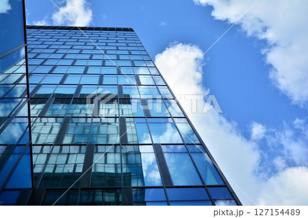 Modern sustainable glass office buildings. Exterior view of corporate headquarters glass buildings architecture.Glass windows in energy-efficient buildings. Financial business center buildings. Modern sustainable glass office buildings. Exterior view of corporate headquarters glass buildings architecture.Glass windows in energy-efficient buildings. Financial business center buildings. 127154489