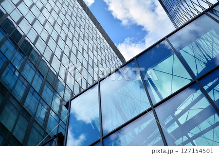Modern sustainable glass office buildings. Exterior view of corporate headquarters glass buildings architecture.Glass windows in energy-efficient buildings. Financial business center buildings. Modern sustainable glass office buildings. Exterior view of corporate headquarters glass buildings architecture.Glass windows in energy-efficient buildings. Financial business center buildings. 127154501