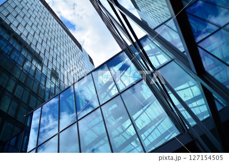 Modern sustainable glass office buildings. Exterior view of corporate headquarters glass buildings architecture.Glass windows in energy-efficient buildings. Financial business center buildings. Modern sustainable glass office buildings. Exterior view of corporate headquarters glass buildings architecture.Glass windows in energy-efficient buildings. Financial business center buildings. 127154505
