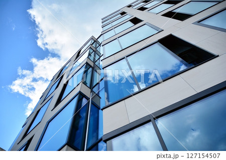 Modern sustainable glass office buildings. Exterior view of corporate headquarters glass buildings architecture.Glass windows in energy-efficient buildings. Financial business center buildings.  127154507