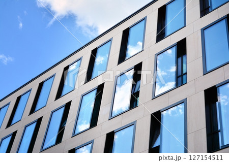 Modern sustainable glass office buildings. Exterior view of corporate headquarters glass buildings architecture.Glass windows in energy-efficient buildings. Financial business center buildings. Modern sustainable glass office buildings. Exterior view of corporate headquarters glass buildings architecture.Glass windows in energy-efficient buildings. Financial business center buildings. 127154511