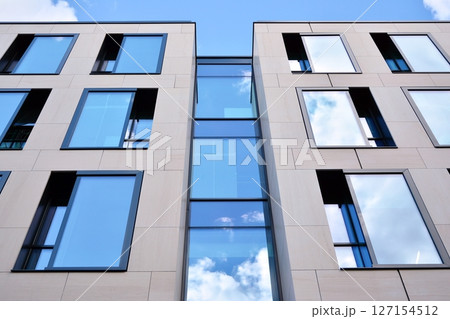 Modern sustainable glass office buildings. Exterior view of corporate headquarters glass buildings architecture.Glass windows in energy-efficient buildings. Financial business center buildings. Modern sustainable glass office buildings. Exterior view of corporate headquarters glass buildings architecture.Glass windows in energy-efficient buildings. Financial business center buildings. 127154512