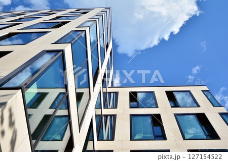 Modern sustainable glass office buildings. Exterior view of corporate headquarters glass buildings architecture.Glass windows in energy-efficient buildings. Financial business center buildings.  127154522