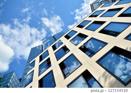 Modern sustainable glass office buildings. Exterior view of corporate headquarters glass buildings architecture.Glass windows in energy-efficient buildings. Financial business center buildings.  127154530