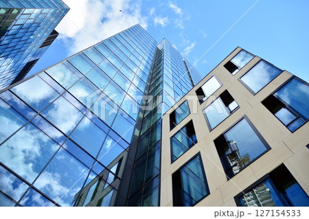 Modern sustainable glass office buildings. Exterior view of corporate headquarters glass buildings architecture.Glass windows in energy-efficient buildings. Financial business center buildings.  127154533