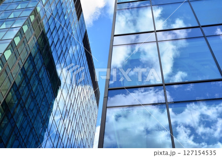 Modern sustainable glass office buildings. Exterior view of corporate headquarters glass buildings architecture.Glass windows in energy-efficient buildings. Financial business center buildings.  127154535